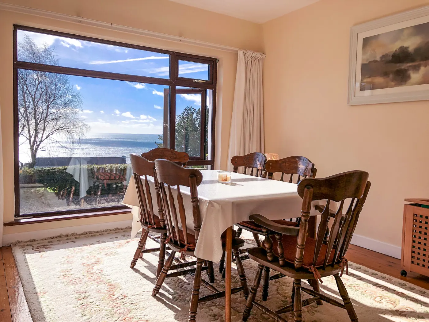 Dining table beside a large sea-view window