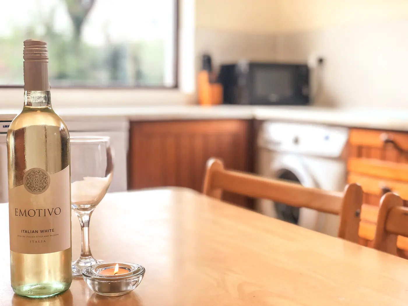 A bottle of wine on the kitchen table