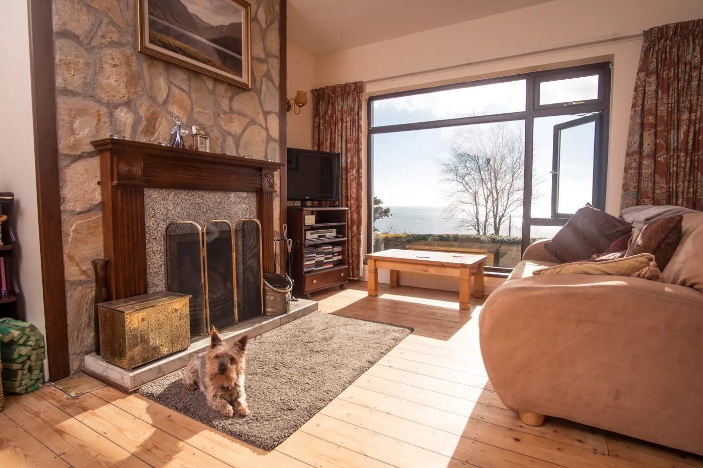 Living room with wood-burning stove and sea-view window